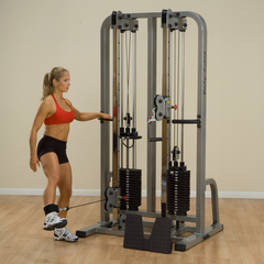Person using PCL dual cable machine with 160 lb stacks for full body workout in a home gym.