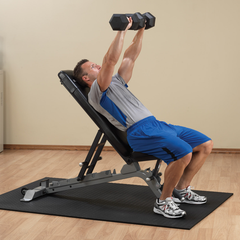 Man performing dumbbell press on Body-Solid SFID325 adjustable bench in a gym setting.