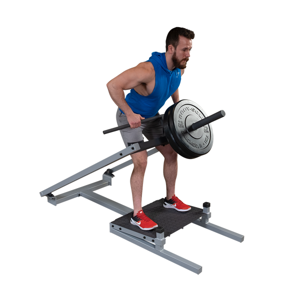 Man performing T-bar row exercise on Body-Solid Pro Clubline STBR500 Row Machine with weights.