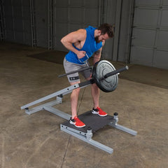 Man using Body-Solid Pro Clubline T-Bar Row Machine with weights for fitness training.