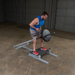 Man using the Pro Clubline T-Bar Row Machine for strength training in a gym setting.