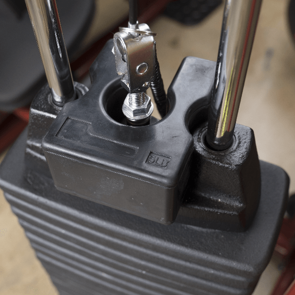 5 lb. weight stack adapter plate securely attached to a machine weight stack, showcasing its robust design made from virgin rubber.
